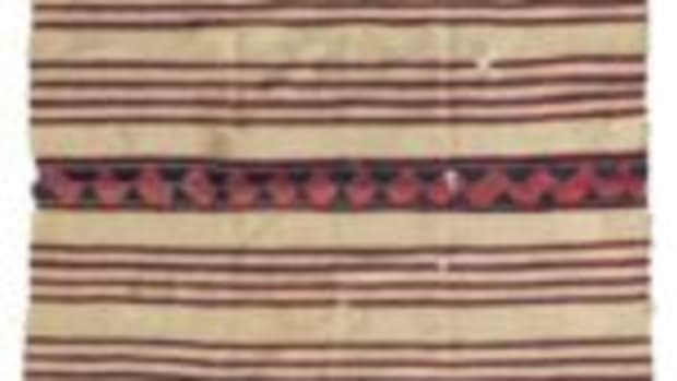 A Navajo classic period child’s wearing blanket, mid-19th century, cochineal and indigo dyes, $93,750.