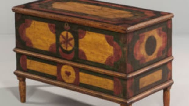 Small geometric paint-decorated blanket chest, 22 1/2 x 32 x 17 in., possibly New York or Pennsylvania, early 19th century. Applied moldings and short turned tapering legs, decorated in yellow, green, red, and black, the designs incorporating quarter-round, heart, and pinwheel elements. Courtesy of Skinner, Inc.