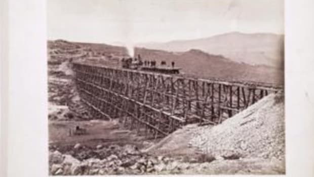 Andrew J. Russell imperial print, “Promontory Trestle Work and Engine No. 2,” plate 222. The locomotive No. 119 is pictured on the trestle bridge and Andrew Russell’s photography wagon is in the valley below.