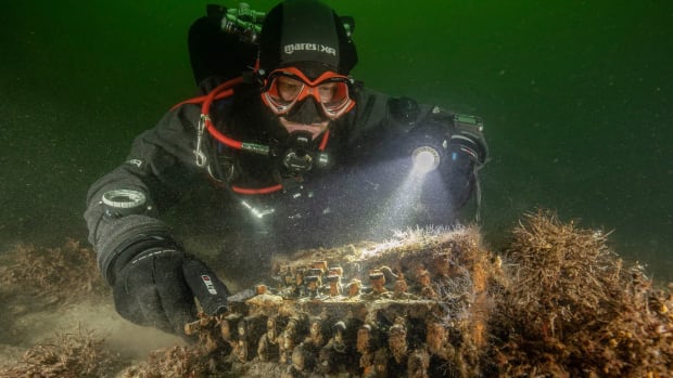 Research diver Florian Huber discovers the Enigma machine at the bottom of the Baltic Sea.