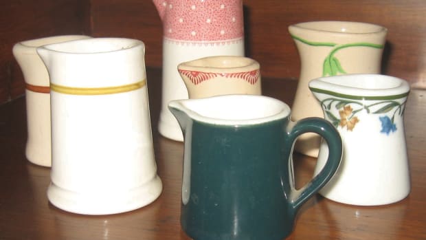 Assortment of seven vintage creamers. The deep green example with handle is actually a cream pitcher.