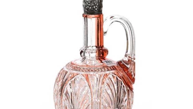 Brilliant Period Cut Glass handled decanter, apricot cut to clear, 11" h, with a beautiful embossed floral sterling silver lidded spout marked Theodore B. Starr and a scalloped pattern cut foot. Estimate: $2,000-$4,000.