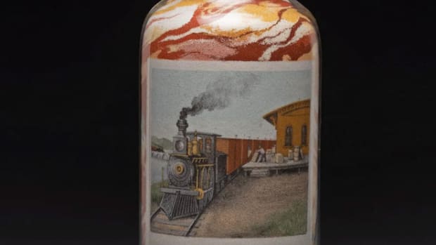 This Andrew Clemens sand bottle, with a railroad theme, sold for $800,000.