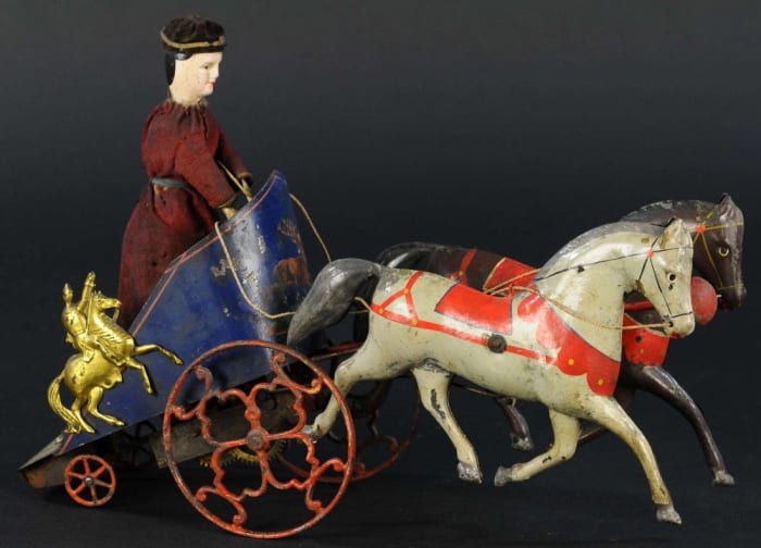 This Ives Hippodrome Chariot, believed to be the best of only a few known examples of the rare toy, was the top seller of Ives offerings, bringing $20,000. It is arguably the most uniquely designed horse-drawn vehicle that Ives produced, featuring a tall figure standing in a clockwork chariot with gold decorated swordsmen at the sides, and a carriage drawn by a team of two hand-painted horses; 14-1/2" l.