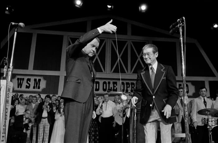President Richard Nixon demonstrates his yo-yo skills to Roy Acuff at the dedication of the new Grand Ole Opry House in Nashville in 1974. Nixon signed the yo-yo and the last time it was sold, it was bought for $16,000.