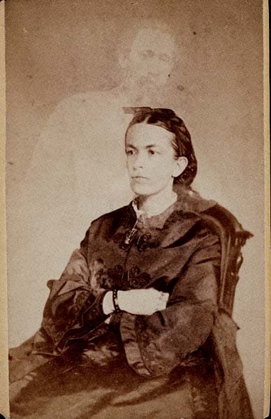 A woman named Fanny Conant with the "ghost" of her brother shown in a photo taken by William Mumler.