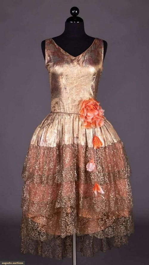 We could see Zelda Fitgerald in this multicolored lamé robe de style, mid-1920s, and like the unusual wheat pattern stamped into the fabric. The Chantilly lace is also pretty and the oversized floral panache of hand-painted silk organza and velvet petals at the left hip adds more flair, not that this dress needs it. Estimate: $500-$800.