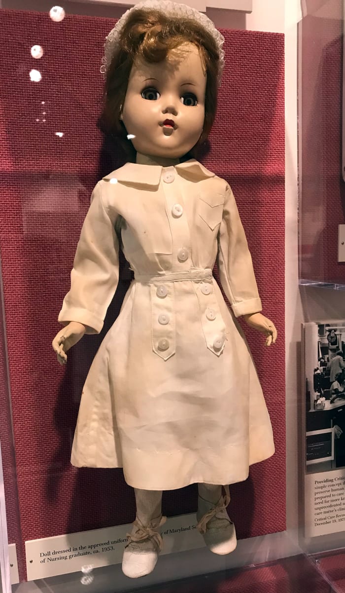 Dolls dressed in the uniforms of both student and graduate nurses were taken on recruiting trips to local schools in the 1940s and 1950s. This doll is dressed in the graduate uniform and âFlossieâ cap of the University of Maryland School of Nursing.