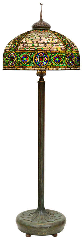 The top lot in the sale is this Tiffany Studios "Byzantine" floor lamp, early 20th century, leaded glass, patinated bronze shade with a reproduction floor base shade impressed "Tiffany Studios, New York," 78" h, 26" diameter (shade); estimate: $150,000-$250,000.