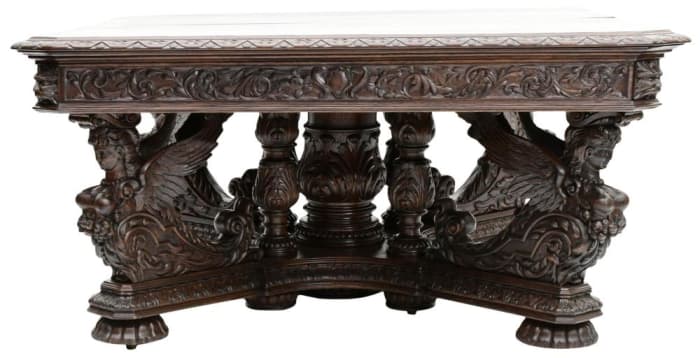 Hertz Brothers figural carved oak banquet table, late 19th century, featuring four winged maidens and includes eight leaves; estimate: $12,000-$15,000.
