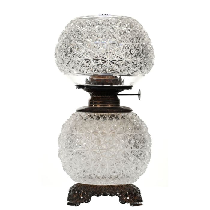 American Brilliant Cut Glass oil lamp in the Persian pattern, 13-1/2" h, with no chimney, removable oil font and a mounted metal base. Estimate: $1,000-$2,000.