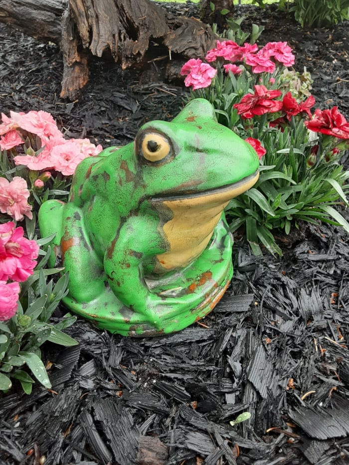 An early Coppertone  frog that is around one inch larger than the later ones. It is 6" h and about  9" l, and sits on a 6-1/2" base; $395.