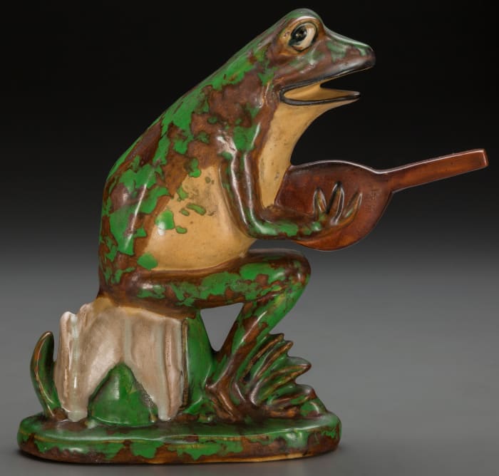 This cheeky garden ornament features a frog playing a banjo - the instrument many people think they sound like. Zanesville, Ohio, circa 1925, “Weller Pottery” mark (shown in the photo below), 7-1/4” h. This sold at auction in 2016 for $1,875.