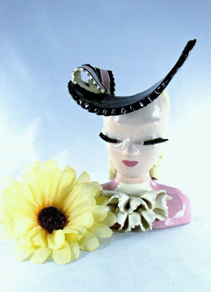 Betty Lou Nichols-made head vase, 1950s, with blond hair, pink ruffled dress and wide-brimmed black hat with bow, signed “Nancy by Betty Lou,” 6-1/4 “ h x 4-5/8” w x 4-3/4” d; $205.