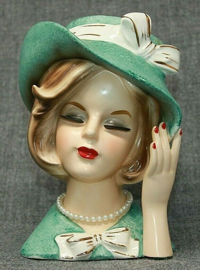 Lady head vase, turquoise with matching wide-brim hat, decorated with white bows, Ardco Fine Quality of Dallas, 6" h; $187.50.