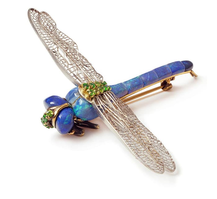 Black opals, demantoid garnets and platinum take flight in this dragonfly brooch by Louis Comfort Tiffany.