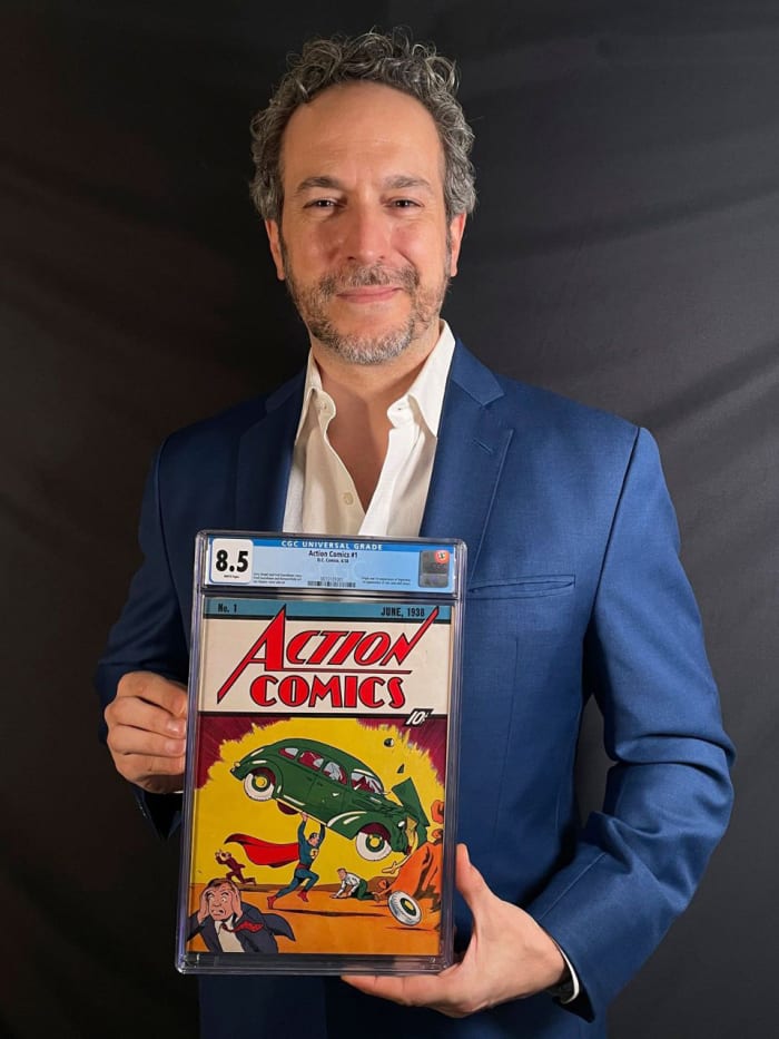 Vincent Zurzolo holding the $3.25-million copy of Action Comics #1.