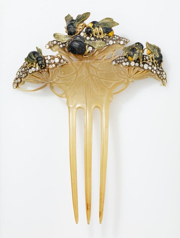 Bees on Flowers: Besides horn, Lalique also experimented with celluloid, from which this comb is made. The comb, 1900, features gold and enamel bees buzzing around diamond-tipped flowers. This piece was ordered in Paris in 1900 by Mrs. Howard Mansfield of New York, and it's likely that she commissioned it while attending the Paris International Exposition.