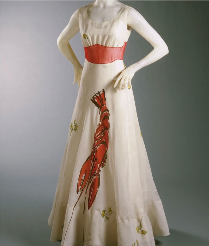 Elsa Schiaparelli collaborated with Salvador Dalí to create this dinner dress in 1937. Commonly known as the lobster dress, Wallis Simpson included the dress in the trousseau she purchased from Schiaparelli prior to her marriage to the Duke of Windsor.