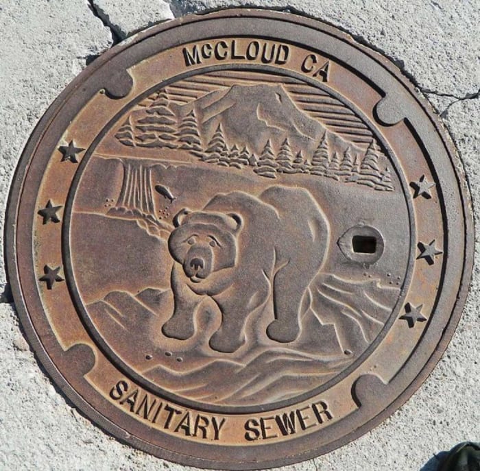 McCloud, California, is nestled at the base of Mt. Shasta, which is featured on its manhole cover, along with a California grizzly bear, the official state animal. 