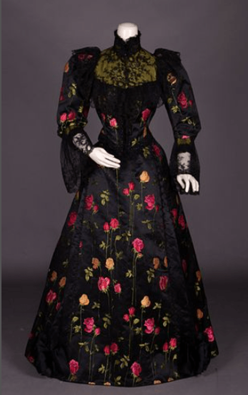 We love how the vibrant brocaded roses really pop on the black silk satin of this dinner dress, circa 1892. We also love the chartreuse silk satin yoke with filigree embroidery and the trimming of black jet. Estimate: $500-$800.