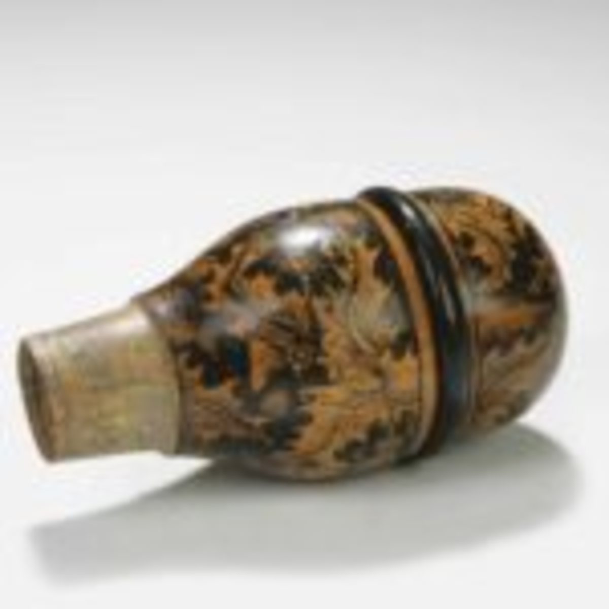 Acorn-form, thistle-decorated Mauchline (Scottish) penwork snuff flask with pewter dispenser, circa 1820, realized $386 including buyer’s premium in 2006. Courtesy of Bonhams, www.bonhams.com