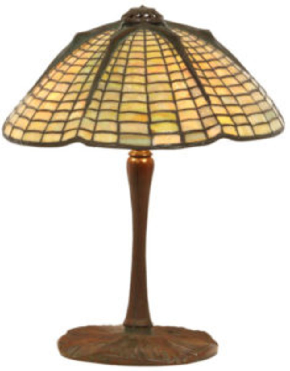 Lighting up the sale is this 15-inch Tiffany Studios Spider table lamp ($15/20,000) having a shade in golden mottled glass in the form of a domical spider web with a stylized six-legged spider running down from the top the shade.
