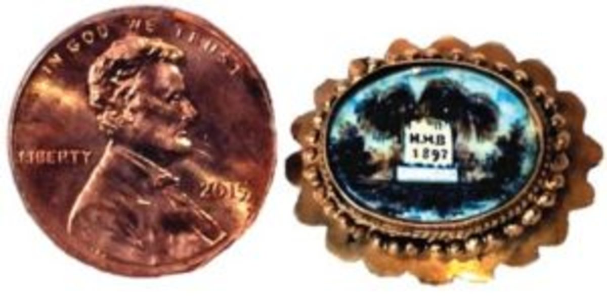 There is a late Victorian mourning brooch. The tiny pin features a fine, hand-painted scene on ivory of a grave with a tombstone amid willow trees; the stone bears the initials “M.M.B.” and the date “1897.” The paints are made from pigment mixed with pulverized hair. Because of the tiny size and single date it is not unreasonable to assume M.M.B. was a child. 