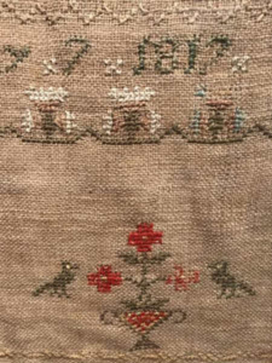  Embroidered alphabet sampler, signed Sarah Mazen, dated May 7, 1817. Sampler features floral motifs, is matted and set behind glass in wood frame, approx. 12" h x 16-1/4" w. Sold for $150. Image courtesy of The Benefit Shop