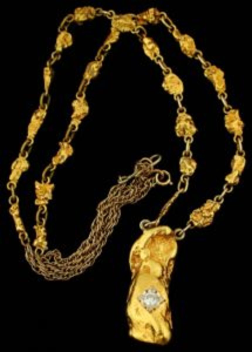 Gold and diamond necklace boasting 24 small gold nuggets (1.11 ozt) and one large gold nugget (1.91 ozt), set with a .5 carat round cut diamond on a 22-inch gold chain (est. $6,500-$8,500).