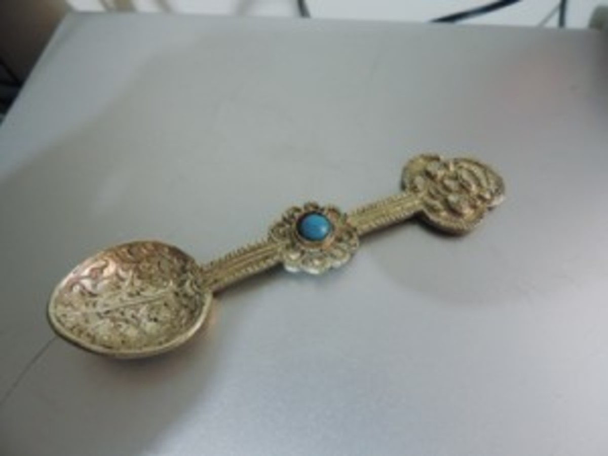 Silver spoon with turquoise colored cabochon stone