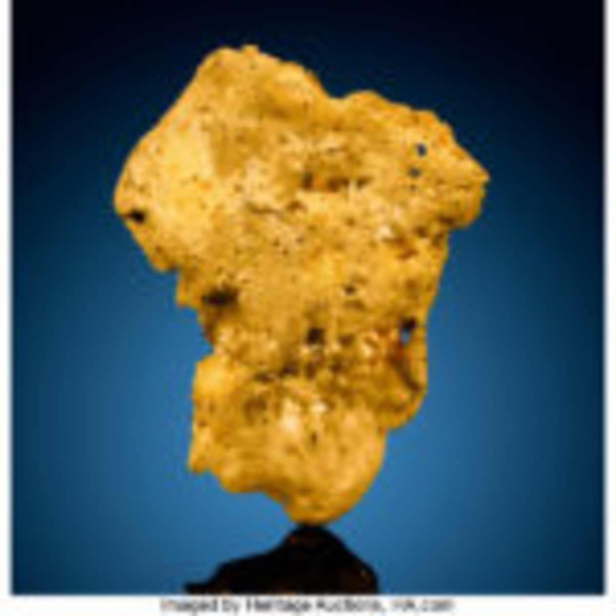 "Aussie" gold nugget, 382.7 grams (12.3 troy ounces), exhibiting a duality of tone as a "skin" of yellow covers the mass of gold in areas affording a layered effect to its overall luster, 2.69 x 2.20 x 0.76 inches, $20,000-$30,000. 