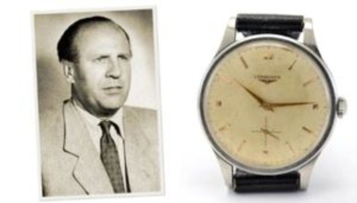 Longines wristwatch belonging to Oskar Schindler, featuring a white face with gold-tone hands and time markers, silver-tone case, and black leather strap.