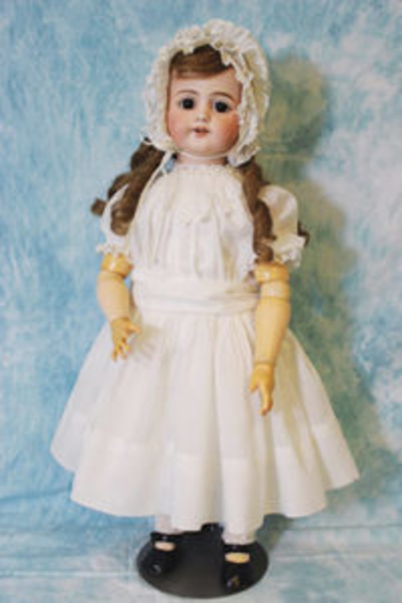 Standing view of Edison Phonograph Doll with its original outfit and shoes. Dress and bonnet are delicately trimmed with lace. Author’s Collection.