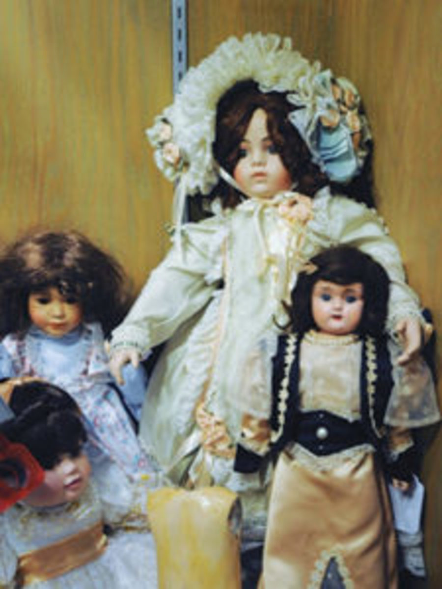  Dolls on display at German American Heritage Center. Front left is a Marie Osmond bisque; at back left is a modern porcelain; the large doll in back is a Pat Loveless Reproduction Bru; near right is a Minerva metal head with all original wig and glass eyes; and front center is a Steiner Body. Photo by Jerry Lowe, dolls from the author’s collection