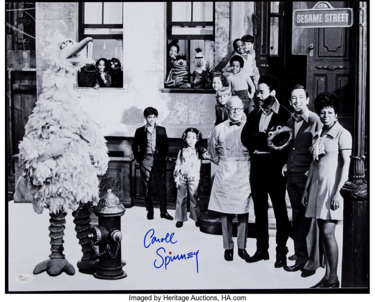  Debuting in 1969, this rare image depicts the full cast of the first season of Sesame Street and is signed by Carroll Spinney (Big Bird). Featured are Big Bird (rookie photo), Mr. Hooper (Will Lee), Gordon (Matt Robinson), Bob (Bob McGrath), and Susan Robinson (Bob’s wife). The rest of the Muppets include Cookie Monster, Grover, Ernie & Burt, and Oscar the Grouch. These were the only Muppets featured in the first season. The iconic “Sesame Street” sign can be seen in the upper right corner. Spinney signed this historic image in mint blue sharpie and added his trademarked red dot, $34. Courtesy of Heritage Auctions