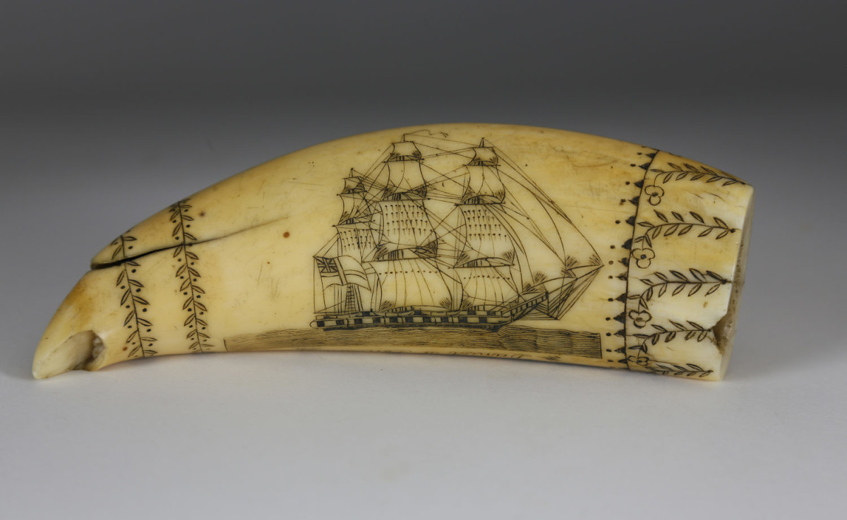 Scrimshaw whale tooth, Daniel of London by the Britannia engraver, first half of the 19th century, titled along the edge “Daniel of London,” obverse depicts a starboard portrait of the Daniel in full sail; the verso engraved with the Daniel half engulfed in fire and rigging breaking free, all within four wrap-around borders; 5-1/2" l, 2" w. Estimate: $10,000-$12,000.