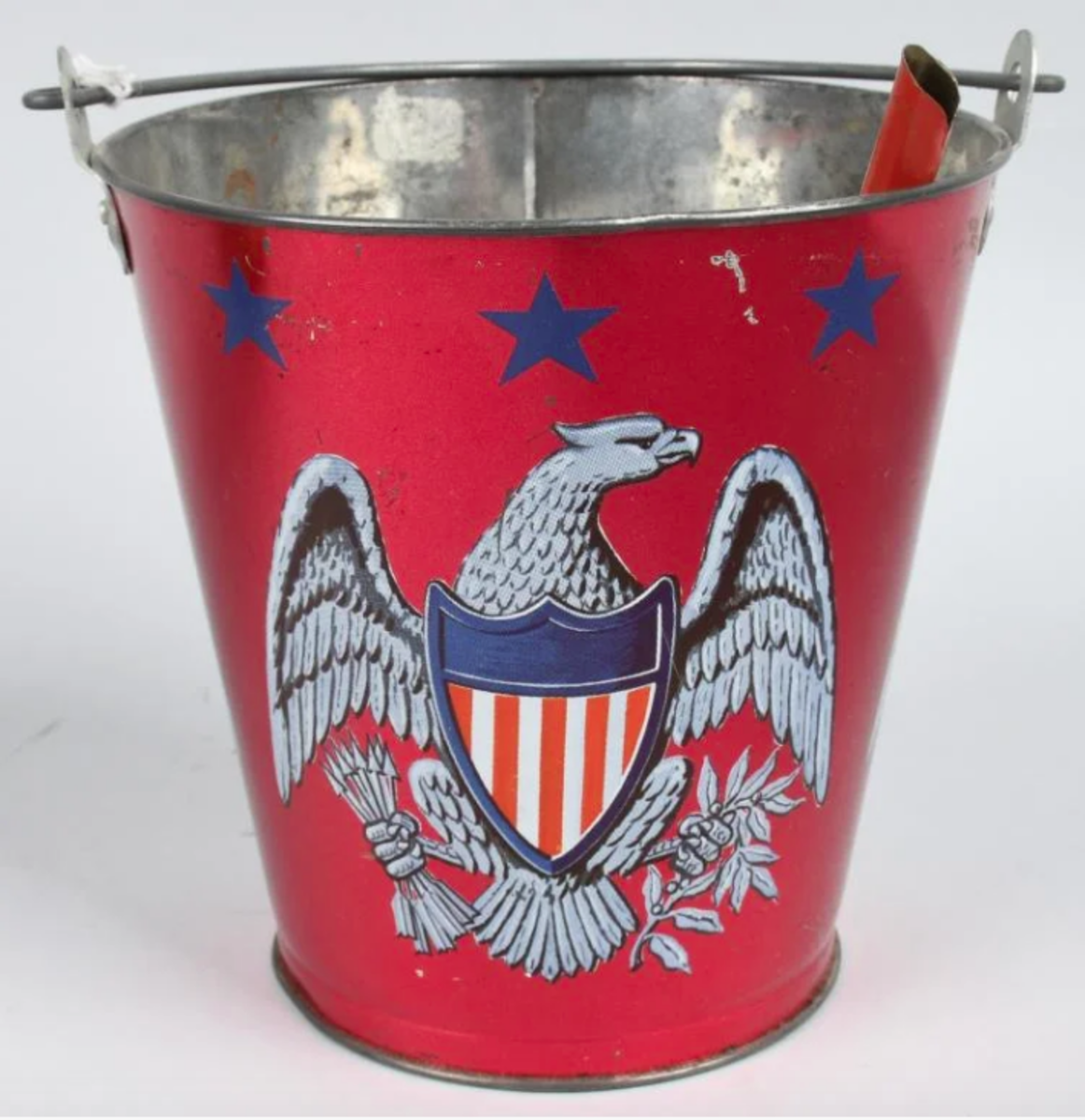 A patriotic-themed pail of a bald eagle with shield, 6” h. This was sold in a lot of two (the other pail is shown below) for $50.