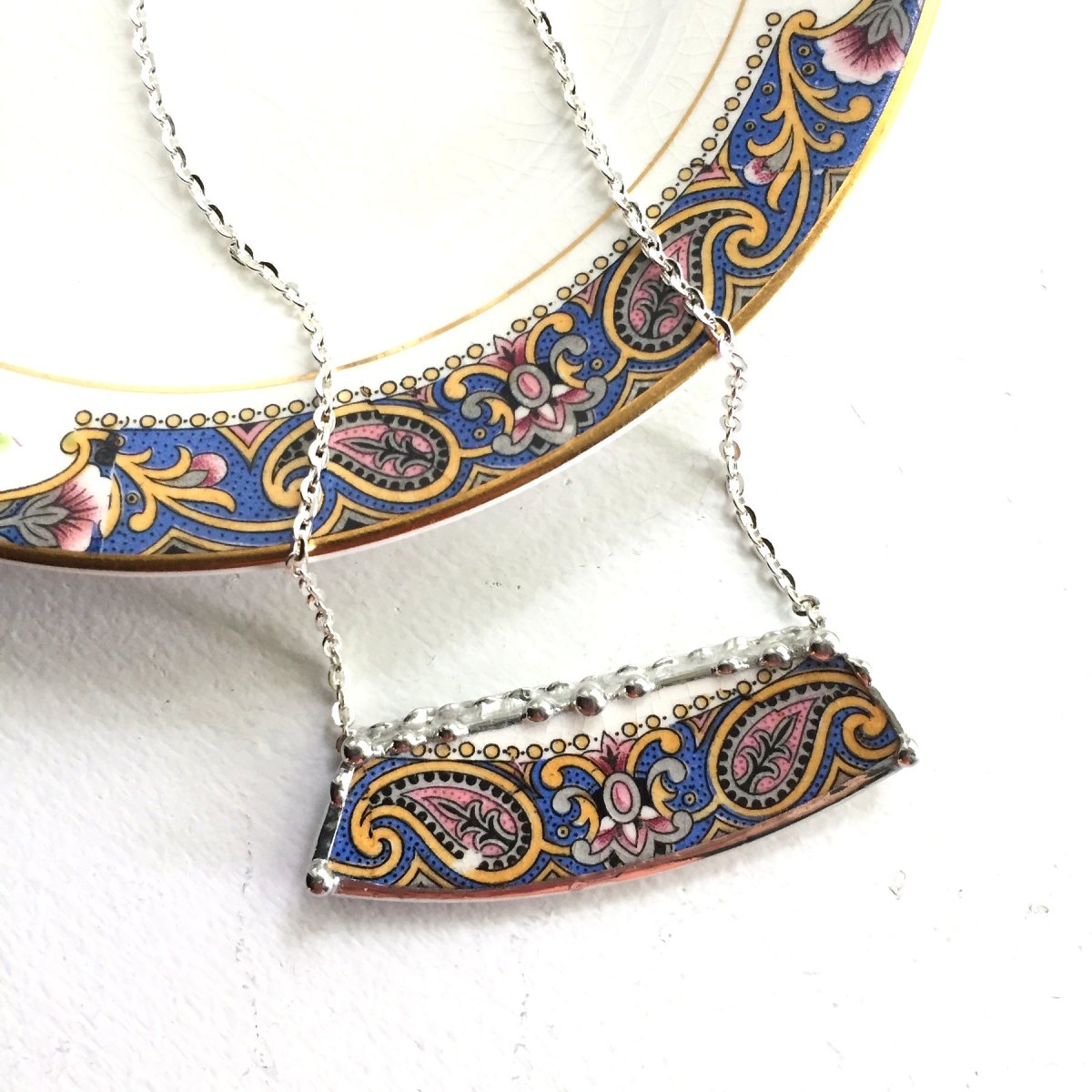 A Boho necklace in blue, from a beautiful antique paisley-designed china dinnerware plate.