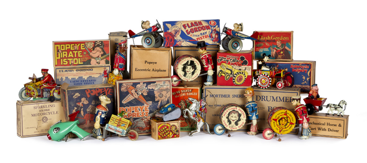 An array of tin toys includes a Popeye Pirate Pistol, a Mickey Mouse Dipsy Car,  Drummer Boy Mortimer Snerd and the Lone Ranger and Silver.