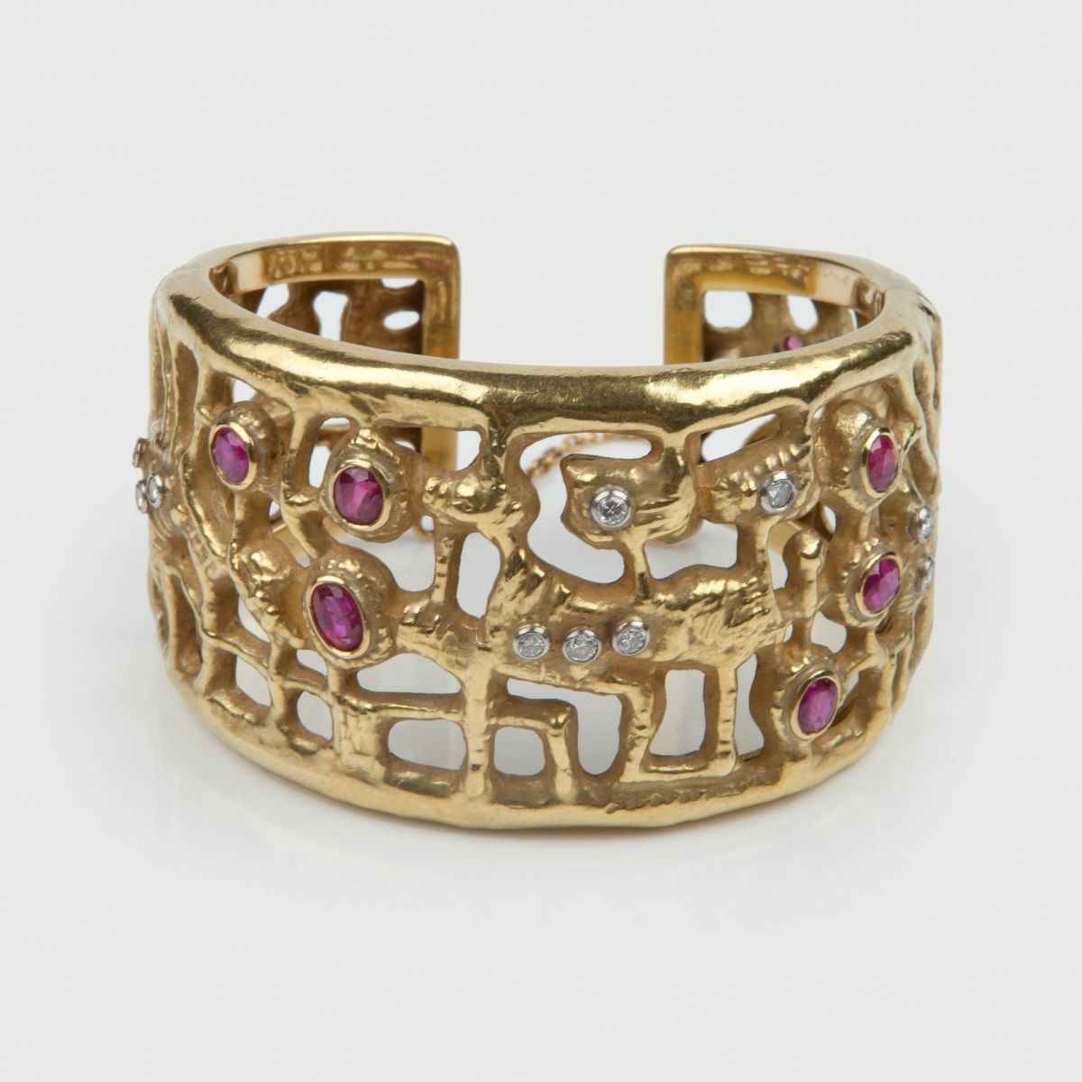 An 18kt gold bangle set with rubies and diamonds, c. 1960, designed by Italian painter Afro Basaldella and made in the workshop of Diderico Gherardi for Mario Masenza, Rome.