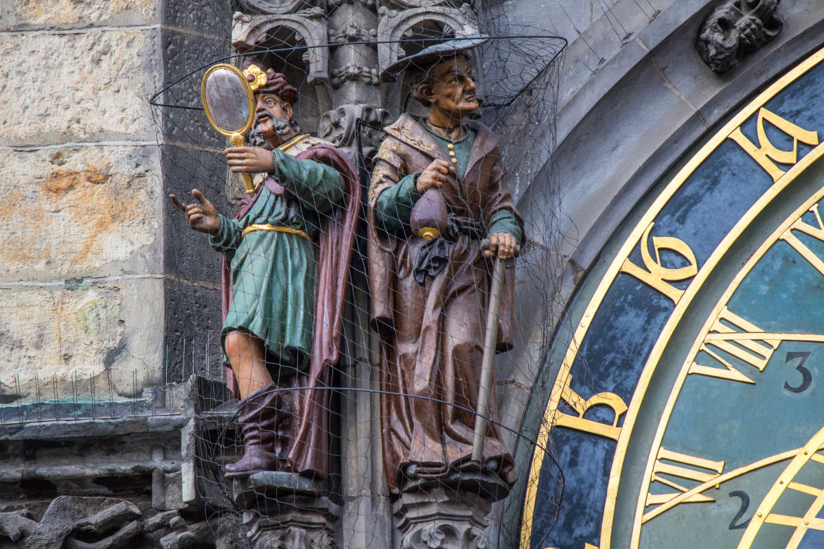 The four figures that flank the dial: The two representing vanity and greed, above, and Death and the figure representing lust, shown below.