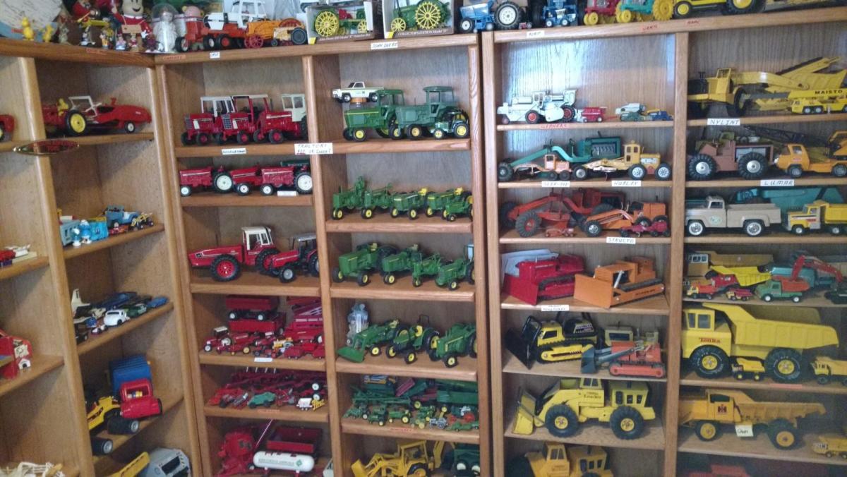 Dump trucks, farm tractors, bulldozers and plenty more vehicles line shelves in one of Ken Mueller’s collection rooms.