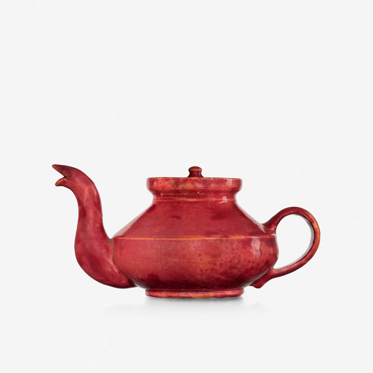 Teapot with snake spout, 1895-96, features a raspberry glaze, 3-1/2” h × 7 w × 4-1/2” d; sold at Rago for $10,000.