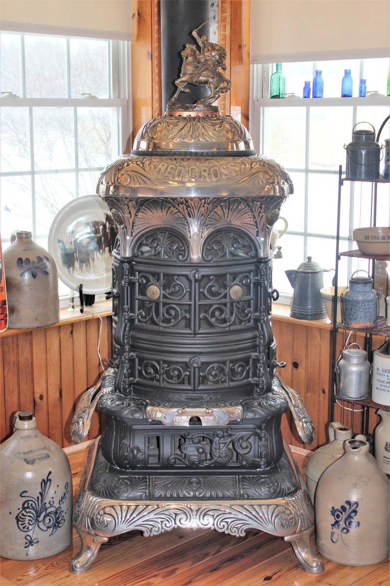 Made for heating a room, this Royal Red Cross coal-burning base burner stove features an ornate knight in armor on horseback atop the stove. The author found the stove dismantled in boxes and had it locally restored.