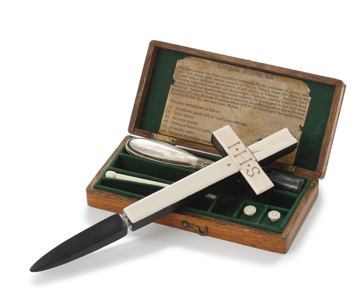 This vampire kit was sold by Sotheby’s in 2012 for $13,750: Continental, circa 1900 and later, comprising a rosewood, ivory and silver gun in the form of a crucifix engraved I.H.S, a silver gun-powder flask, a glass vial, an ebonized wood and silver stake, an ivory ramrod, shells and two silver bullets in a green-felt-lined stained oak box.