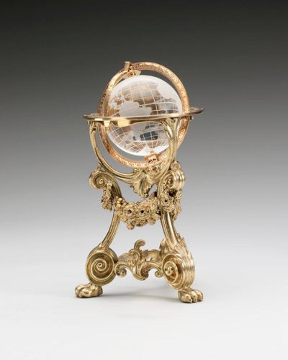 This rock crystal, gold and silver-gilt globe was made sometime before 1896 in the workshop of Erik Kollin, Carl Fabergé’s first head workmaster. It was purchased by Tsar Nicholas II in December 1897 for 350 roubles and was subsequently owned by Prince Vladimir Galitzine, from whom Queen Mary purchased it in December 1928. The globe is geographically correct and swivels within its mounts; 4” x 2-1/2”.