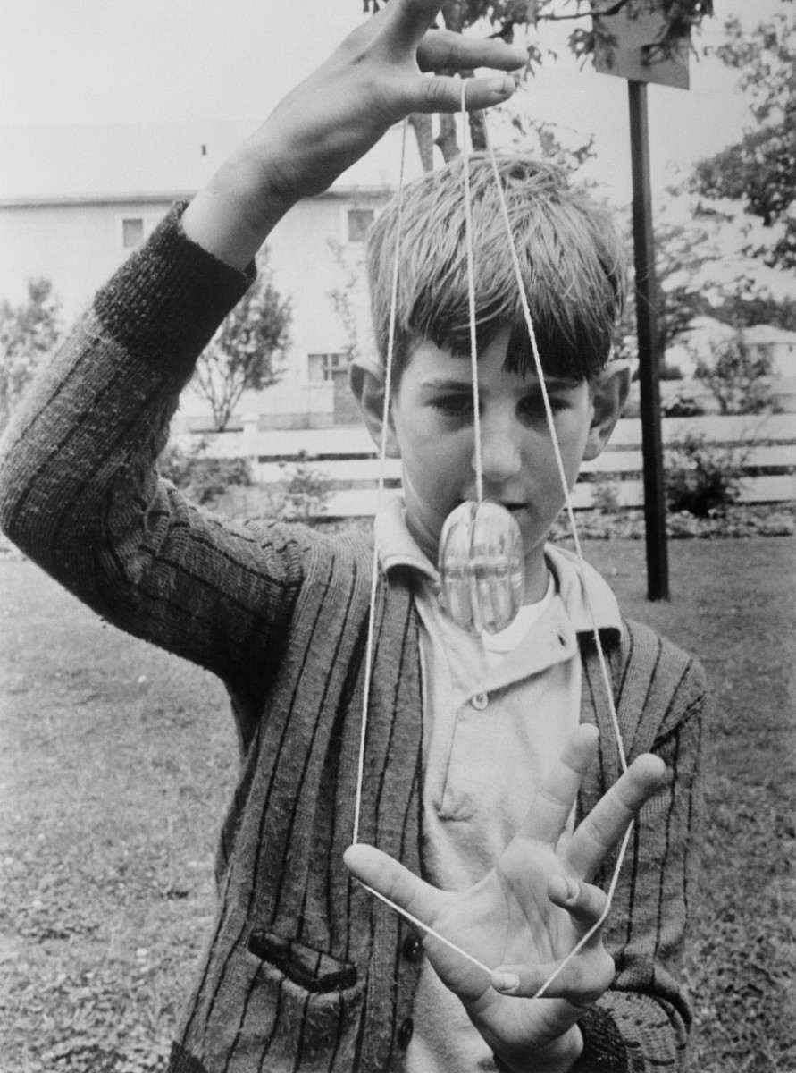 Yo-yos have been mesmerizing kids of all ages for centuries. Here, Richard Lee, 9, of North Massapequa, New York, demonstrates the trick, “rocking the baby,”in 1961. Both hands are used to pull the string into a cradle in which the spinning yo-yo is rocked back and forth. It may look easy, but it has to be done quickly
so that the top doesn’t stop whirling. Beginners who try it run the risk of tying the string up in knots and their fingers as well.
