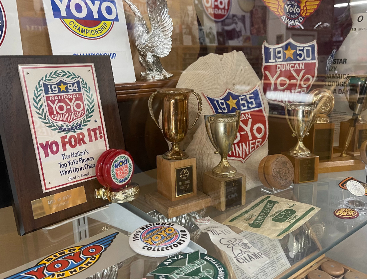 A display case in the museum of some of the awards won by yo-yo champs. Prizes for competitions in the 1950s, including sweaters and patches, are now collectible.