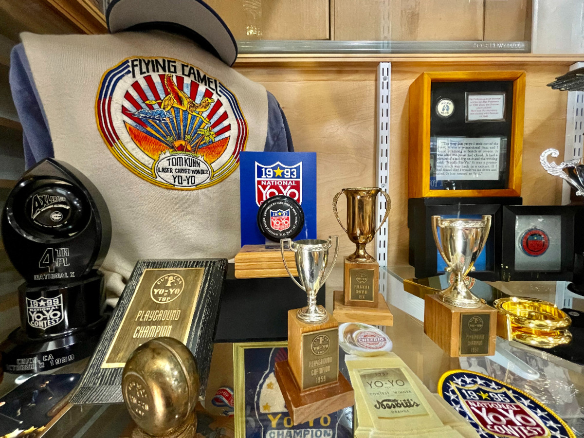 A display case in the museum of some of the awards won by yo-yo champs. Prizes for competitions in the 1950s, including sweaters and patches, are now collectible.